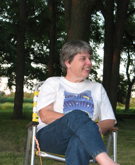 Jan Bechtel relaxing in front of the woods