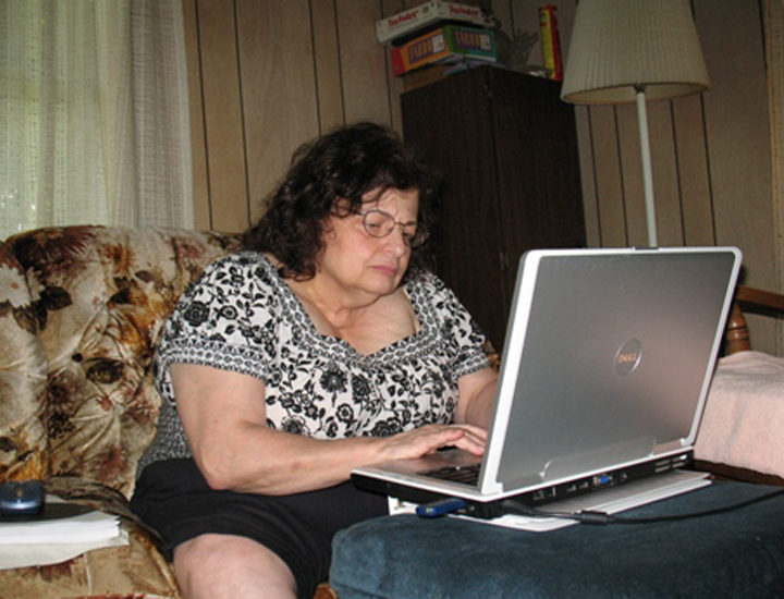 Professor Jerri Courtney writes indoors