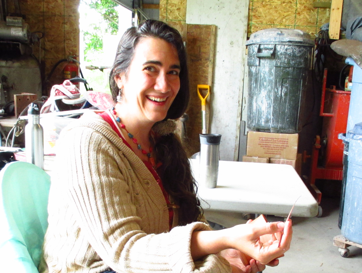 Melissa Hasbrook gets the feel of a feather in her hand