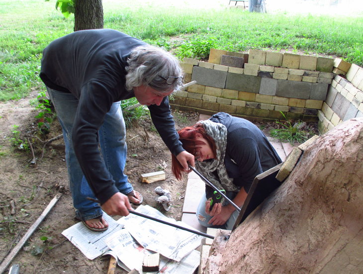 Steve Smith and Rebecca Graves stoke the kiln