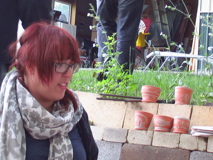 Pots wait patiently to be smoked in the kiln