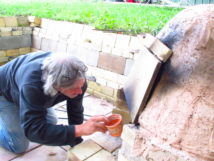 Smith inserts the last of the pots, then he'll add green leaves for smoky soot
