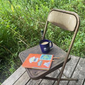 Chair, journal, and tea ready for their writer
