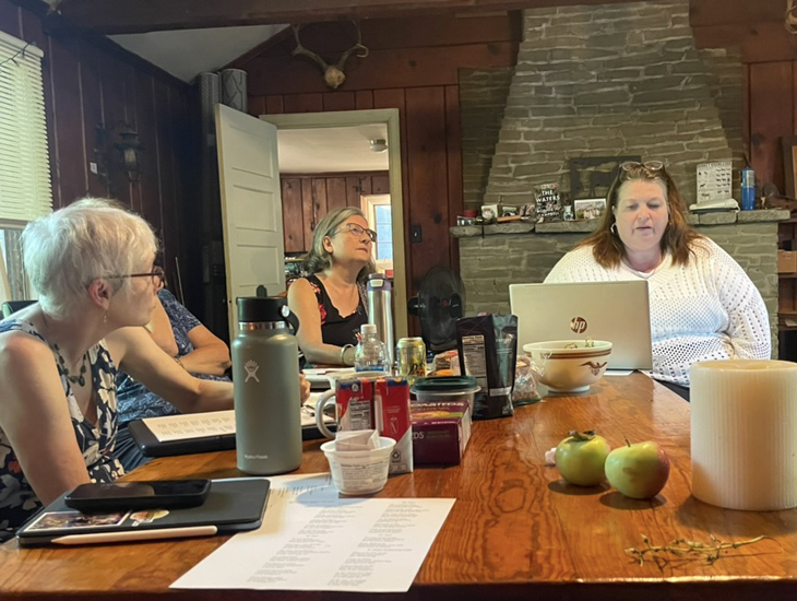 Mary Catherine and Michelle listen to Amy's poem