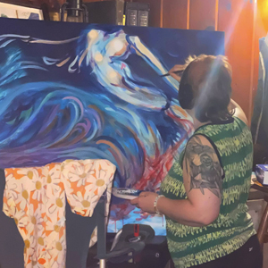 Z the Goblin working on a large acrylic painting, done in shades of blue and purple