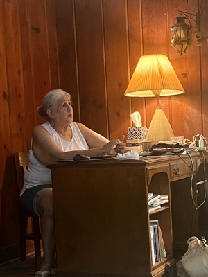 Nina Craig working at the corner desk of the common room