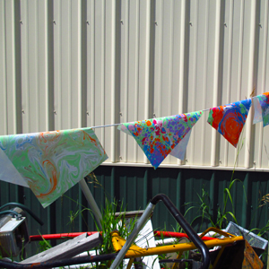 Flags on a line . . . marbling prints drying