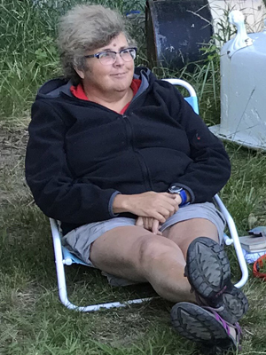 What's that Mona Lisa smile
about? March Bauman in a lounge chair on the gallery grounds