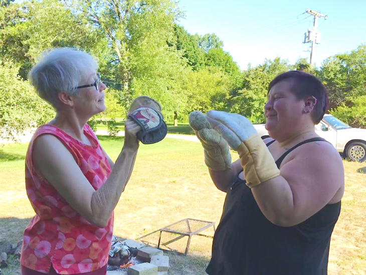 Mary Catherine and Bex spar with pot holders.